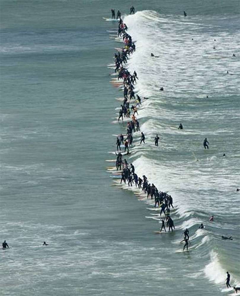 surfers riding wave