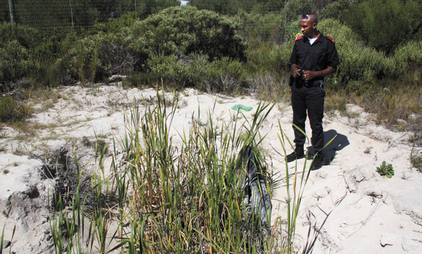 Kids have been sleeping in this deep donga or dried out pond recently. They used black plastic, tied to a pole, stuck in the middle to cover the area as a roof. Signs of clothing and other items were found.