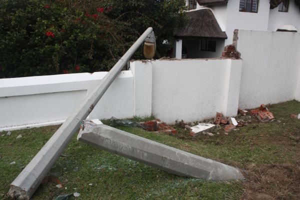 Another view of the damaged pole and wall,