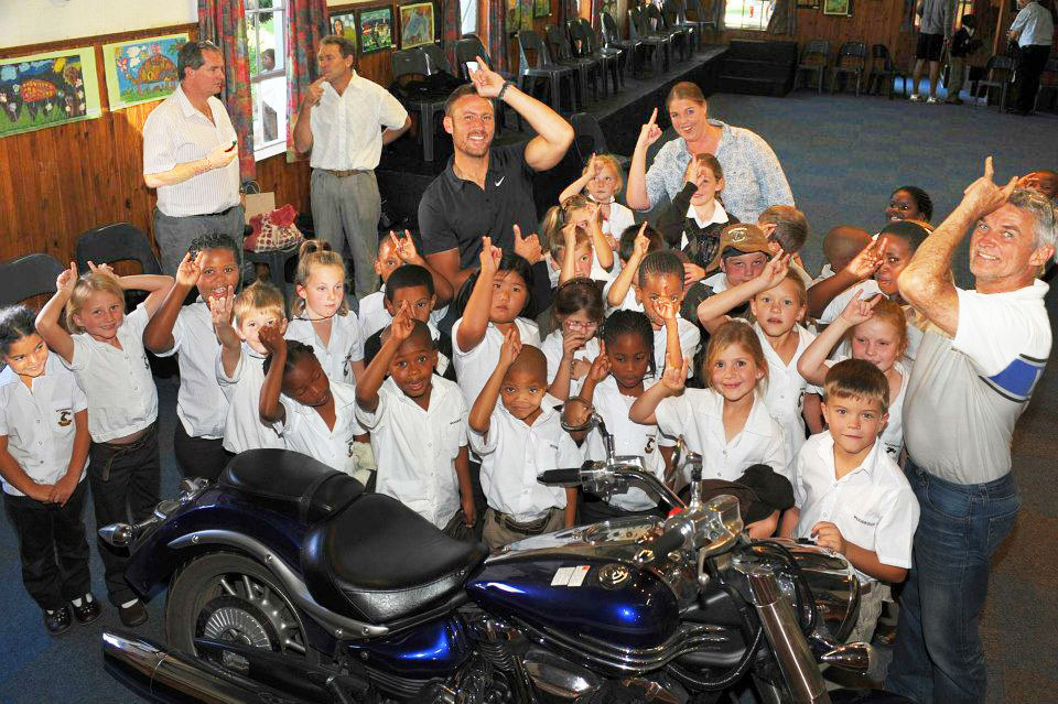 Jason Hartman and Dave Estment seen interacting with excited pupils and staff from Woodridge Prep School. 