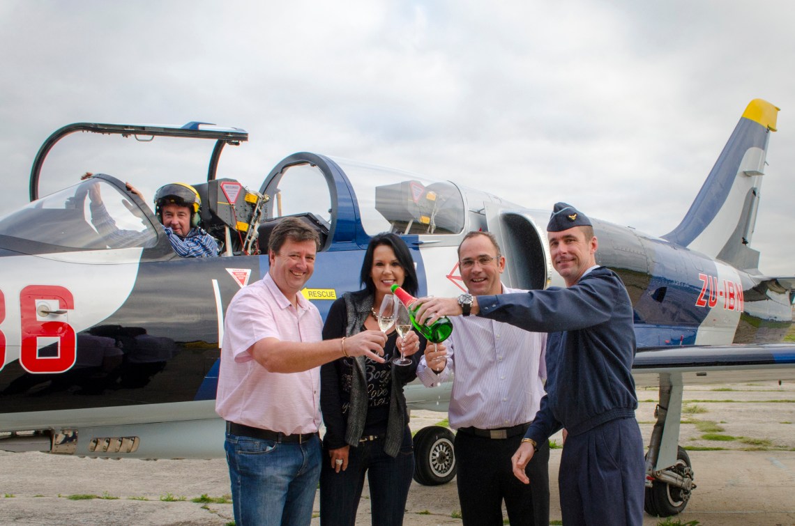  Celebrating Baywest Mall’s sponsorship of the renowned Port Elizabeth air show, now named the Baywest Port Elizabeth Airshow, are (from right) SA Air Force spokesman and museum curator Captain Mark Kelbrick, Baywest MD Gavin Blows, MTR Smit Children’s Haven director and air show convenor Crystal Watson, and air show committee members Andrew Barton and Stu Davidson (in the cockpit of his L39 fighter jet). [picture supplied]  